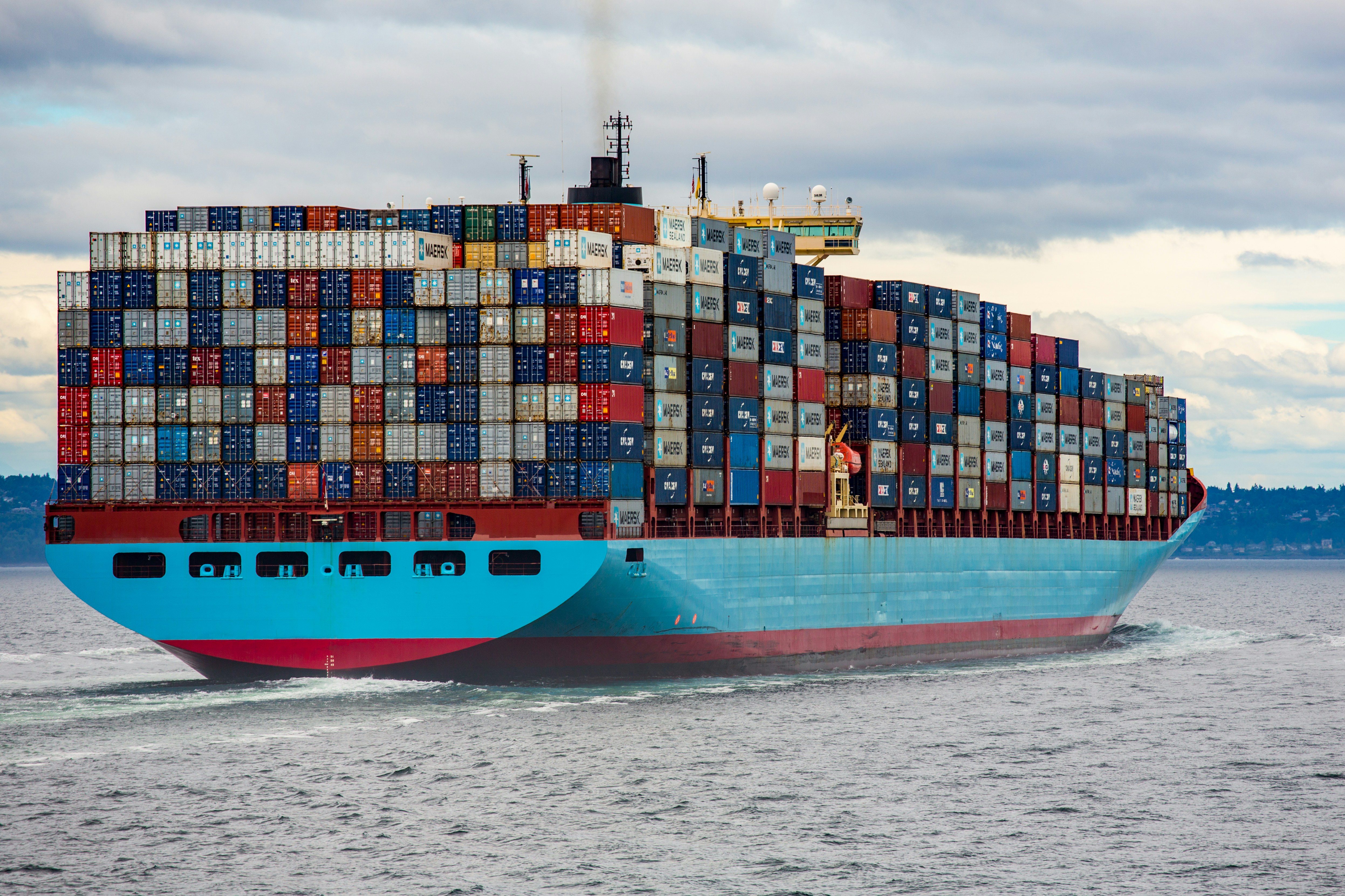 Blue and red cargo container ship on the ocean